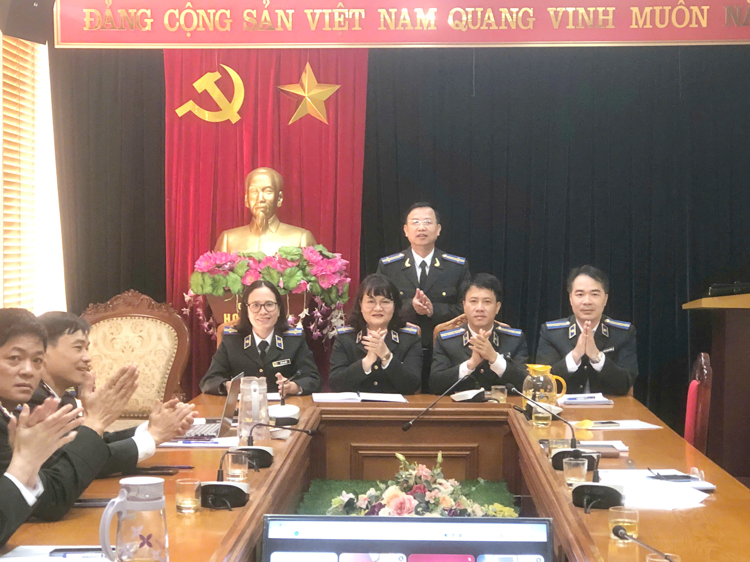 A group of people in uniform standing in front of a tableAI-generated content may be incorrect.